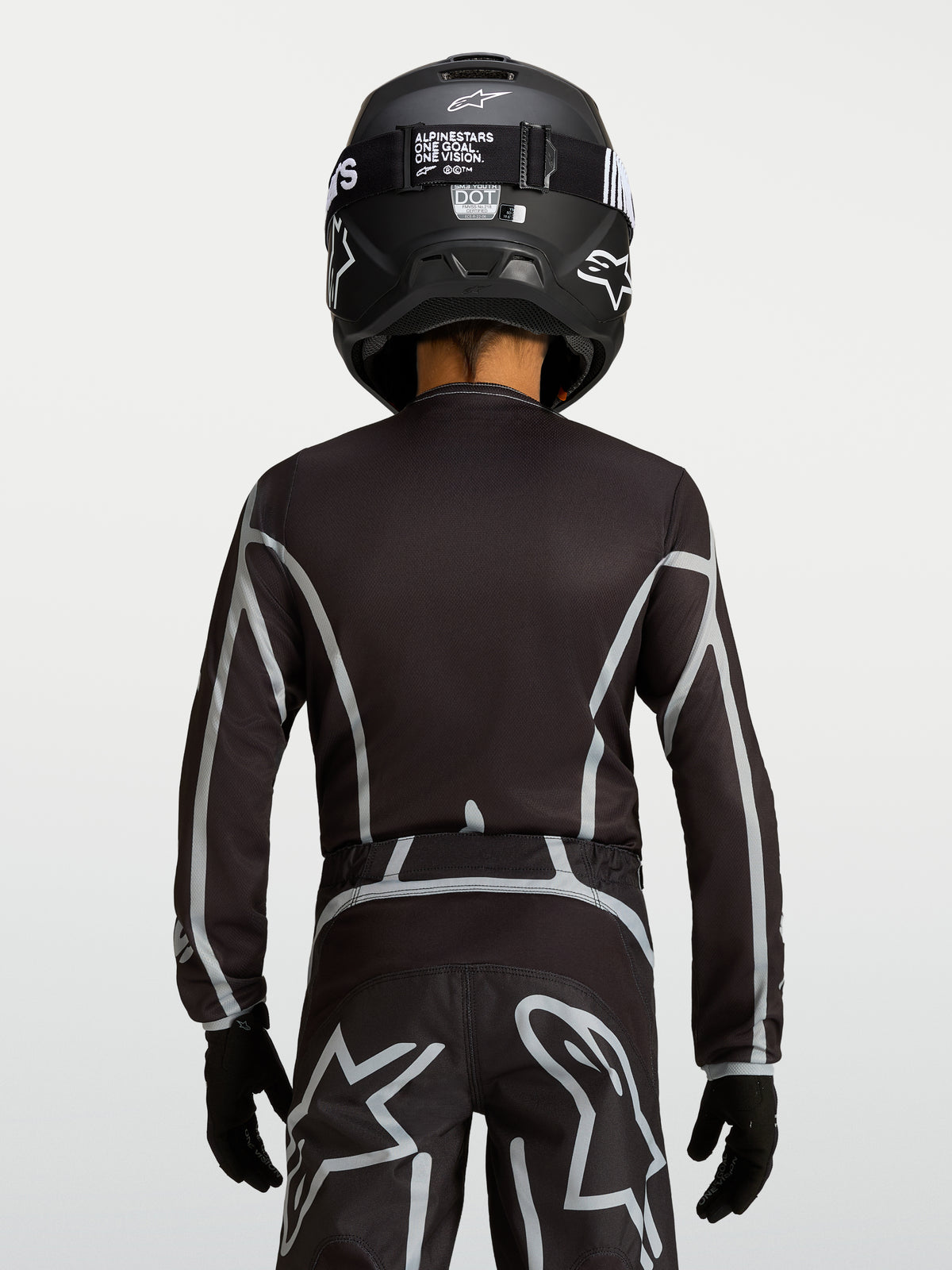Alpinestars Youth Fluid Apex V2 Jersey, Black and Silver motocross top with ergonomic fit and extended rear coverage.