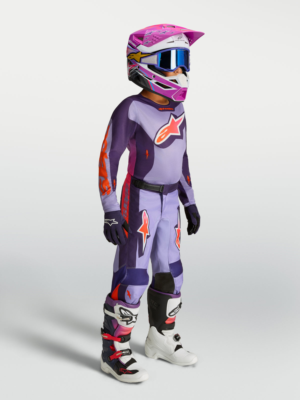 Alpinestars 2027 Youth Fluid Hunt Gear Set, Lila und Pink Fluo, Motocross-Trikot und Hose für Jugend, Offroad-Rennen am Modell.