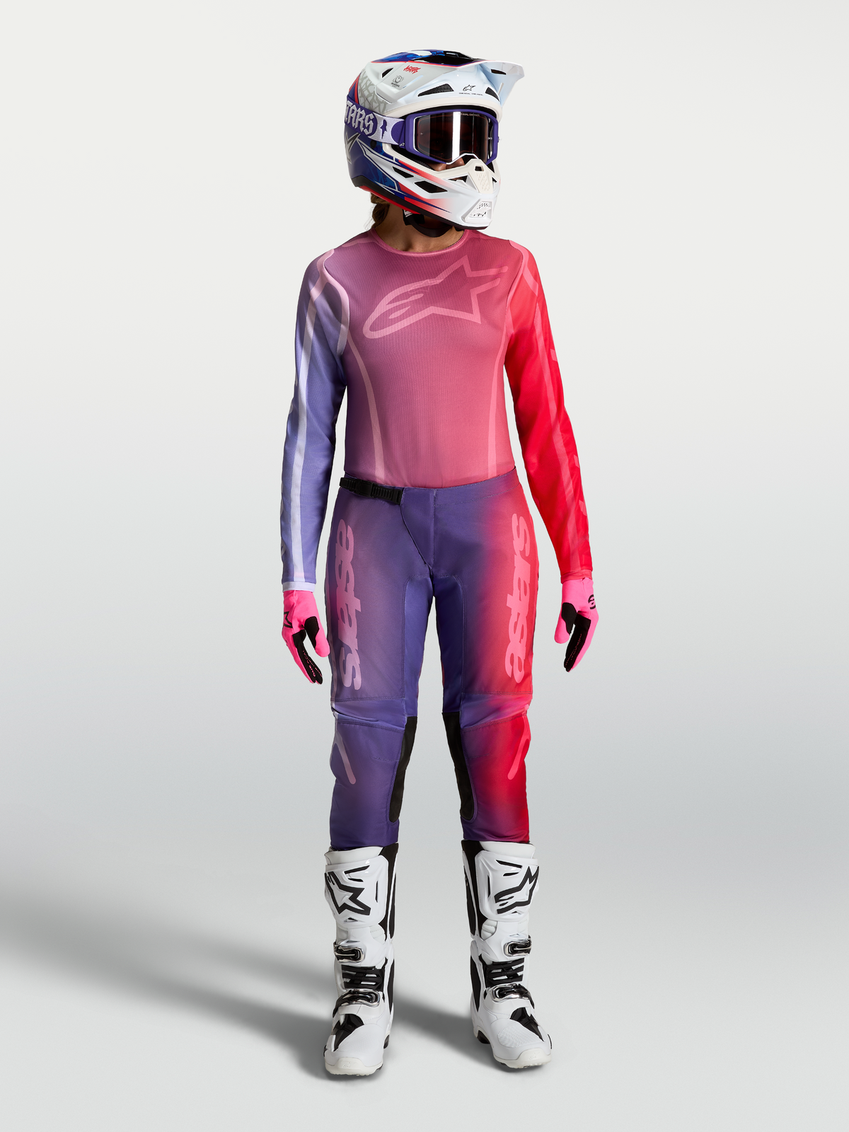 Alpinestars Stella Fluid Kepler Trikot, Damen-Motocross-Ausrüstung in Lila und Rot mit passender Hose und Helm.