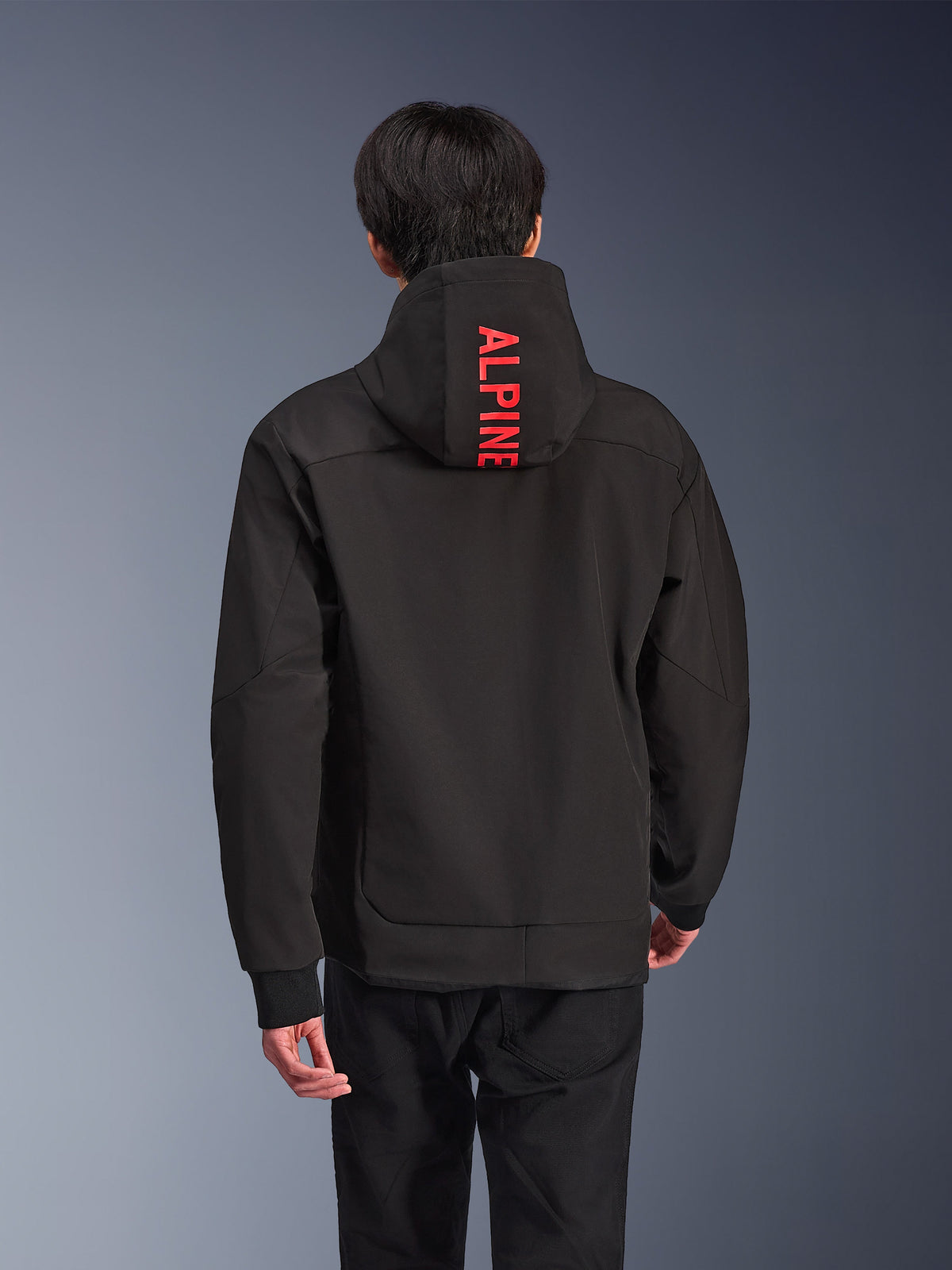 Alpinestars Radium Tech Hoodie, urban motorcycle jacket, black with bright red branding, back view featuring vertical 'ALPINE' text on the hood, 3-layer technical shell with ribbed cuffs, modern athletic design