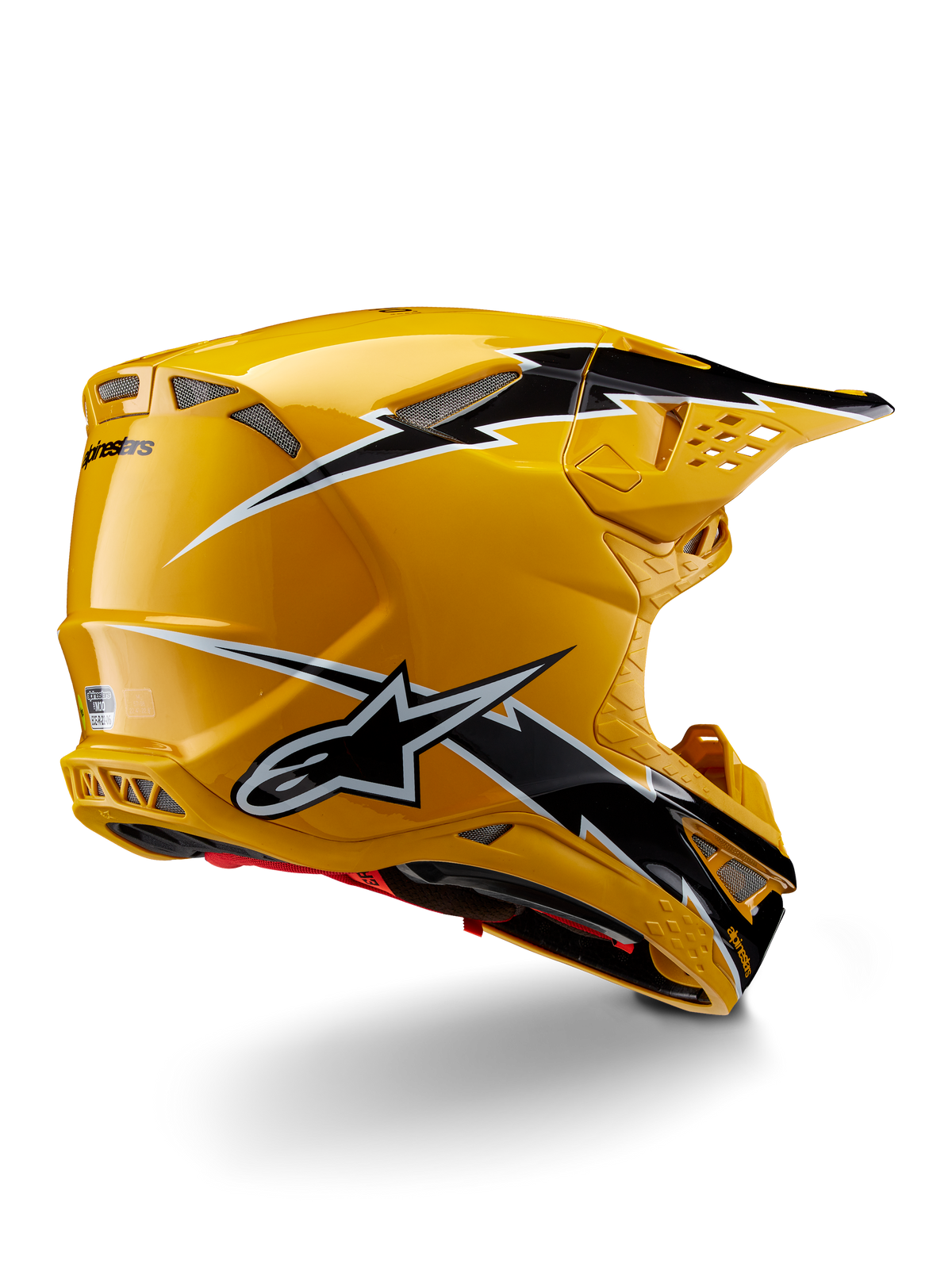 Alpinestars Supertech M10 Ampress Helm, Motocross-Helm, Schwarz Gelb Glänzend, hochglänzendes gelbes Finish mit schwarz-weißen Grafiken im Blitz-Stil, Dreiviertelansicht von hinten mit aerodynamischer Schale und integrierten Belüftungsöffnungen.