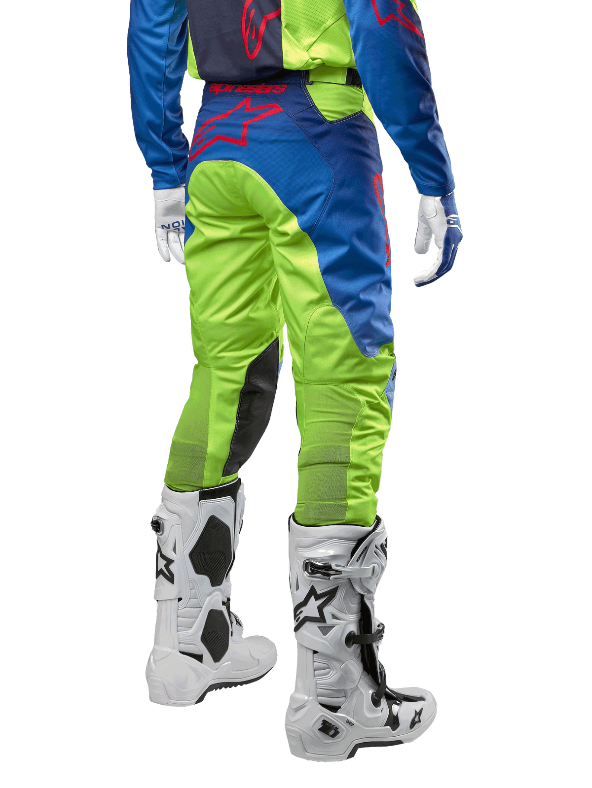 Alpinestars 2024 Racer Hoen Hose, Motocross-Hose, Gelb Fluo und Blau Night Navy, Rückansicht, mit rotem Alpinestars-Logo, getragen mit passendem Jersey, weißen Handschuhen und weißen Motocross-Stiefeln, strapazierfähiges Textil für Offroad-Rennsport