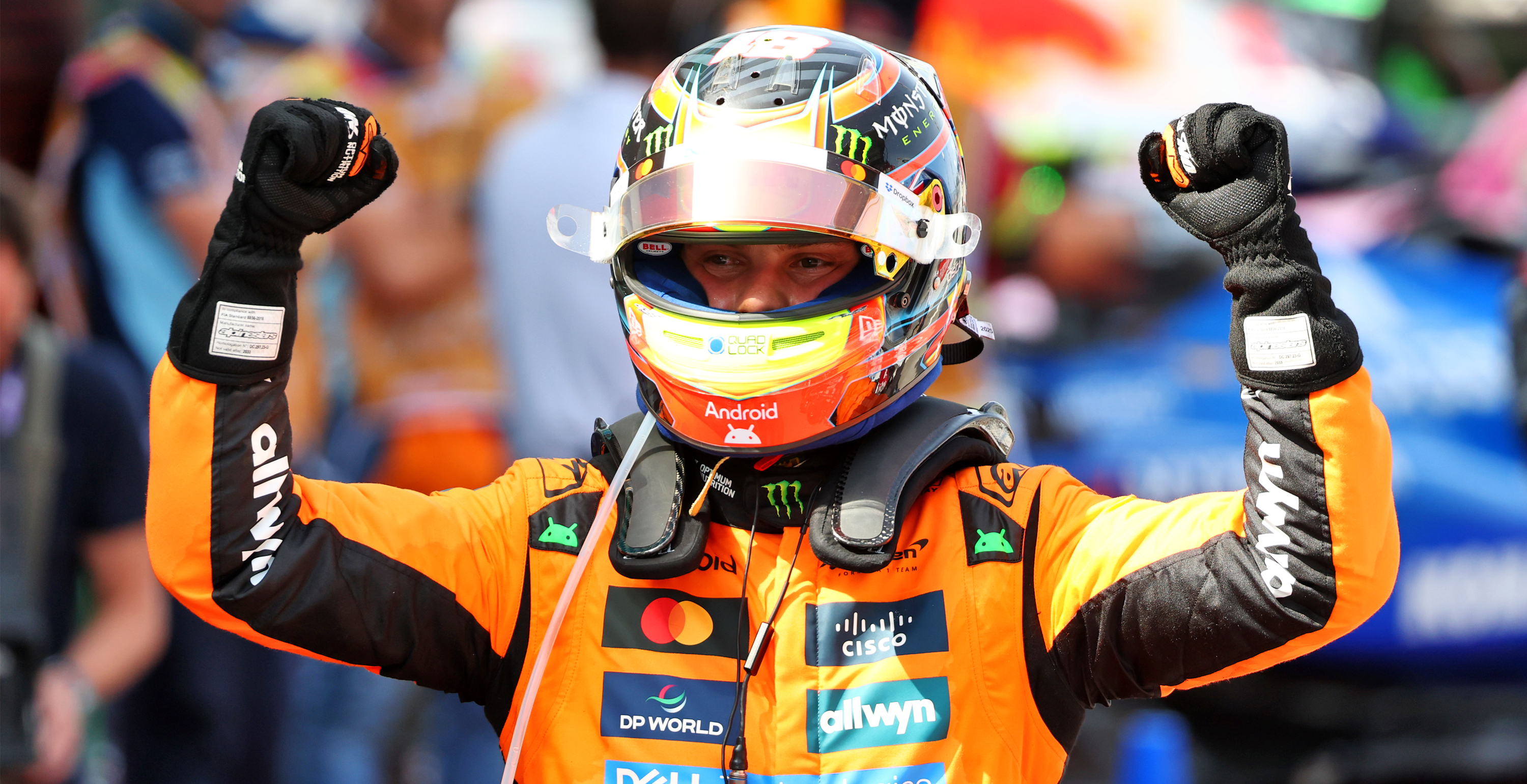 Oscar Piastri celebrating wearing helmet and Alpinestars gear