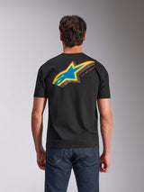 Alpinestars Angler CSF Tee, Short Sleeve T-Shirt, Black, back view showing vibrant multi-color Astars logo with perforated fill and 'RACING AHEAD' text, worn with blue jeans, casual motorsport-inspired apparel