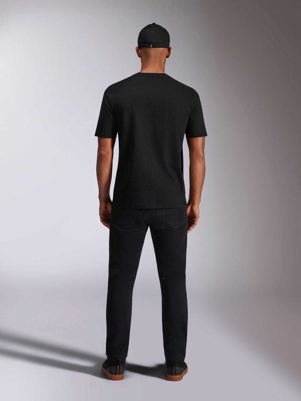Alpinestars Ellipsoid CSF Tee, Short Sleeve T-Shirt, Black, Back view worn by model with black cap and pants, casual motorsport-inspired streetwear
