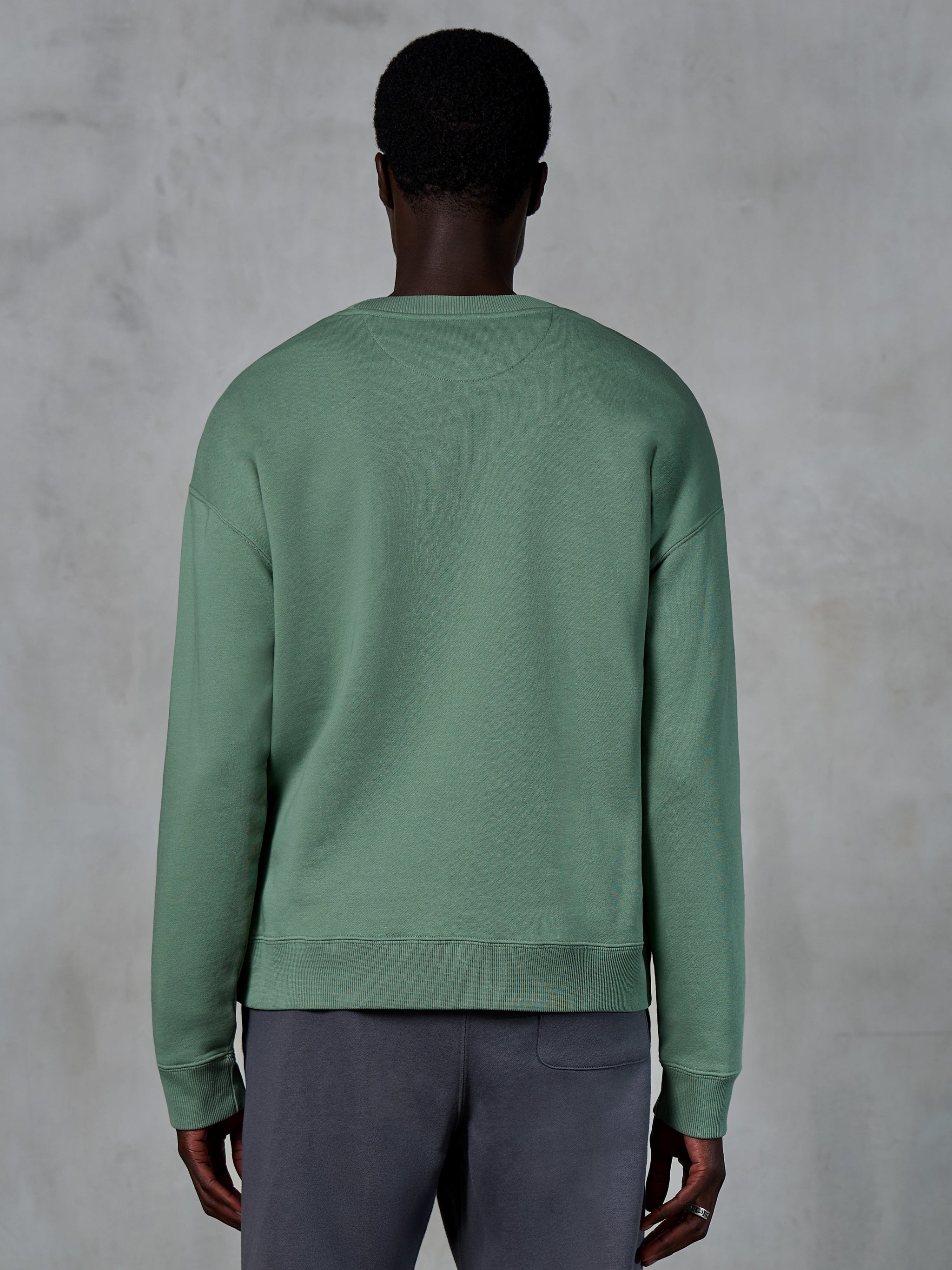 Alpinestars Essentials Ageless Crew, Rundhals-Sweatshirt, Kaktusgrün, Rückansicht am Model, gerippte Bündchen und Saum, hochwertiges Kompakt-Fleece, lässige Lifestyle-Streetwear