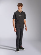 Alpinestars Frontal CSF Tee, Short Sleeve T-Shirt, Black, White Astars Logo on Chest, worn by a model with dark jeans and black sneakers, Casual Performance Streetwear