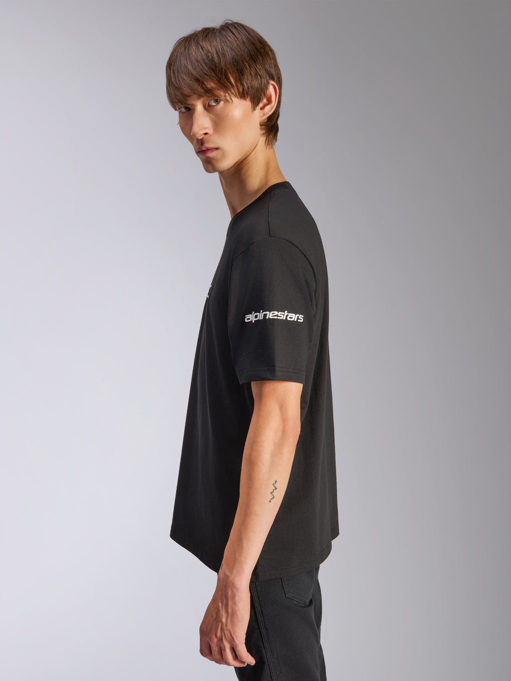 Alpinestars Frontal CSF Tee, Short Sleeve T-Shirt, Black, white Alpinestars logo on sleeve, worn by model in profile view, casual motorsport performance streetwear