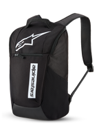 Alpinestars Defcon V3 Backpack, Daily Backpack, Black and White, featuring a large white Astar logo and vertical Alpinestars wordmark, front zippered pocket, padded air-mesh shoulder straps, durable 600D polyester, casual motorsport-inspired design
