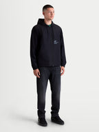Alpinestars Speeder Resolve Windbreaker Jacket, Lightweight Men's Sportswear Hooded Windbreaker, Black, featuring a mesh-lined interior, adjustable drawstring hood, and signature motorsport-inspired branding on the chest and sleeve, shown on model for urban layering.