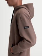 Alpinestars Camino Textured Oversized Hoodie, Casual Sportswear Pullover, Taupe Brown, Textured Knit Twill Fleece, side profile view showing woven sleeve label and high collar.
