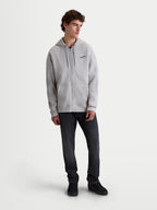 Alpinestars Entity Oversized Hoodie, Sportswear-Kapuzenjacke mit durchgehendem Vislon-Reißverschluss, Unisex, Zementgrau, hochwertiger Baumwoll-Fleece-Mix mit Kängurutasche und gesticktem Astars-Logo, am Modell präsentiert für einen entspannten Alltags-Lifestyle.