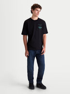 Alpinestars Post Oversized CSF T-Shirt, Kurzarm-Sportswear-T-Shirt, Schwarz mit türkiser Astars Wortlogo-Grafik auf der Brust, Oversized Fit, weiches Baumwollmischgewebe, am Modell gezeigt.