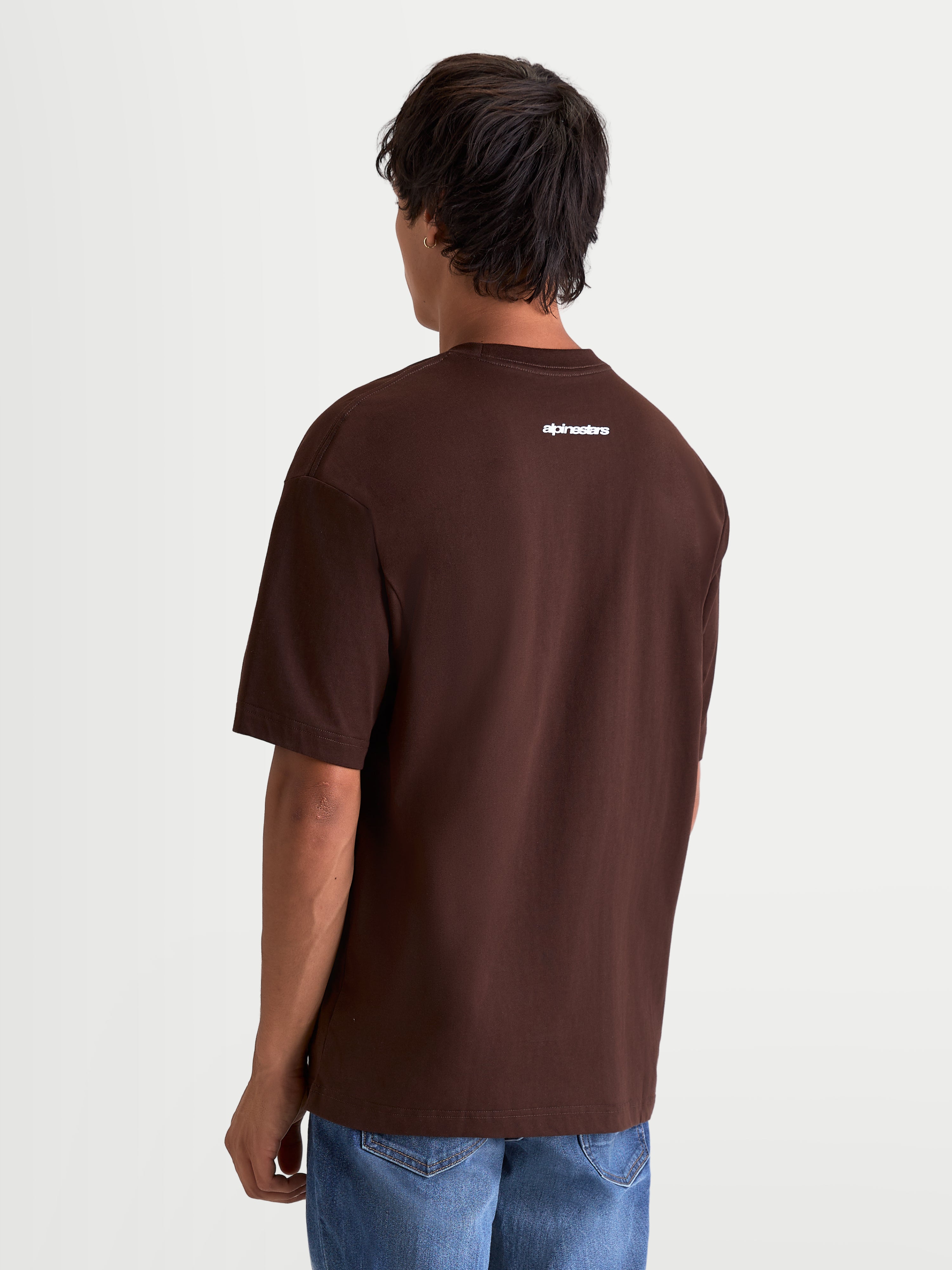 Alpinestars Prelude Oversized CSF T-Shirt, Kurzarm-Sportswear-T-Shirt in Braun, Rückansicht am Modell mit weißer Alpinestars-Wortmarke auf dem oberen Rücken, locker geschnittene Oversized-Passform.