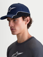 Alpinestars 500 Snapback Hat, Sportswear Baseball Cap, Unisex, Navy Blue and Black, Durable Cotton Twill, features curved bill and 3D Astars logo embroidery with white contrast piping, on-model side view.