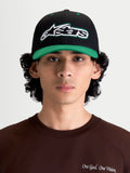 Alpinestars Retro Snapback Kappe, Sportswear Lifestyle Cap, Schwarz und Grün, mit gebogenem Schirm, strukturierter Krone und frontal gesticktem Astars-Logo mit grünem Zierstich, Modell-Frontansicht.