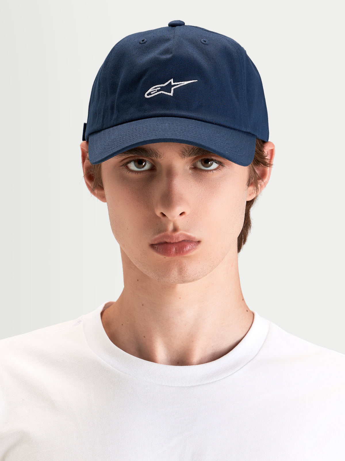 Alpinestars Dylan Dad Hat, casual sportswear cap in navy blue with white Astars logo embroidery, curved bill and unstructured low crown worn by a model