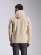 Alpinestars Ageless V3 Hoodie, off-white, back view, casual sportswear, featuring a jersey-lined hood, long sleeves with ribbed cuffs and hem, worn with dark denim jeans