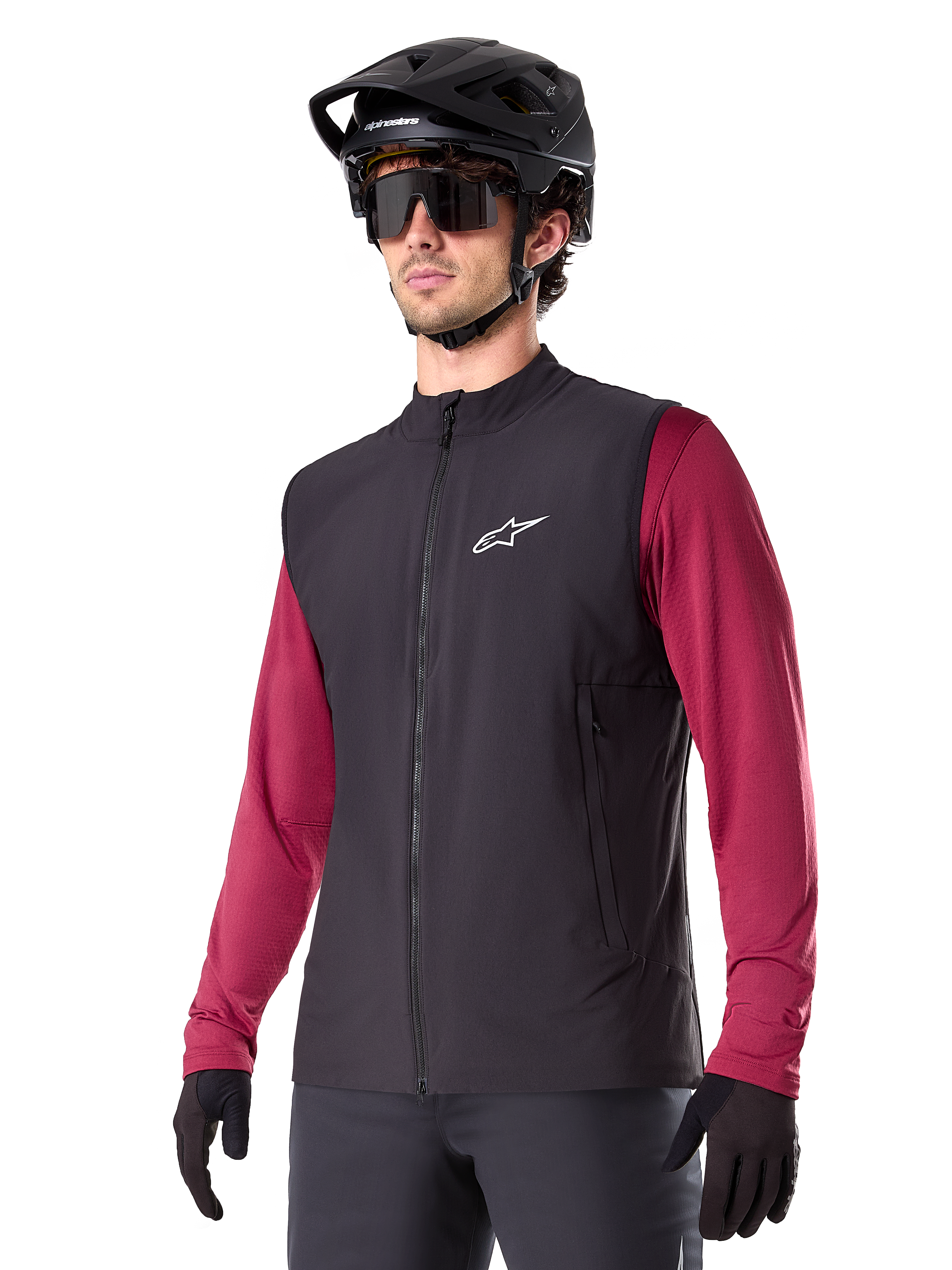 Alpinestars A-Dura Thermal Vest, Black, Cycling Thermal Gilet, worn over a maroon long-sleeve shirt, featuring a white chest logo, paired with a black MTB helmet and sunglasses, insulated performance layer for mountain biking