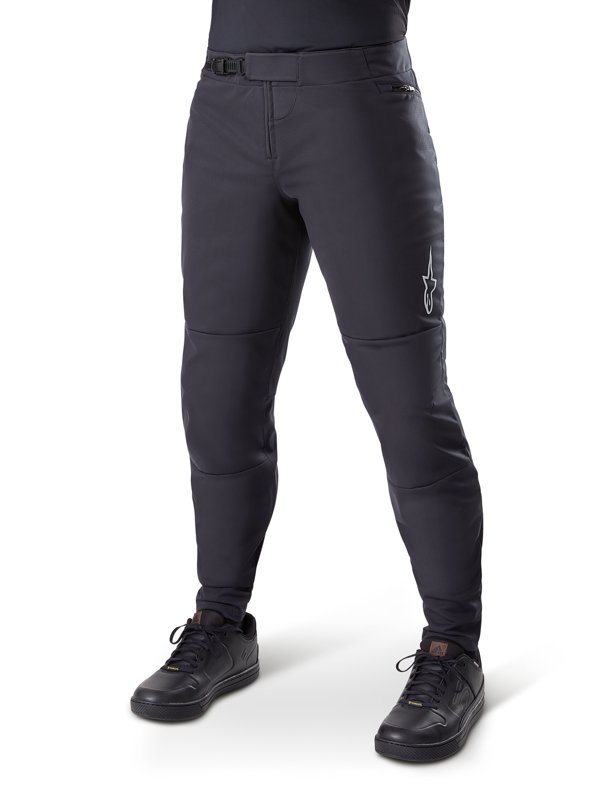 Alpinestars A-Dura Thermal Pant, Black Mountain Bike Pants, worn with black cycling shoes, featuring a ratchet waist closure, small white logo on the thigh, tapered fit for cold-weather riding