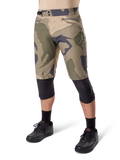 Alpinestars A-Dura Camo Liner Shorts, Mountainbike-Shorts, braunes Camo-Muster, Vorderansicht mit Reißverschlusstaschen und seitlichen Taillenverstellern, getragen mit schwarzen Knieschonern und schwarzen Fahrradschuhen, strapazierfähige MTB-Ausrüstung