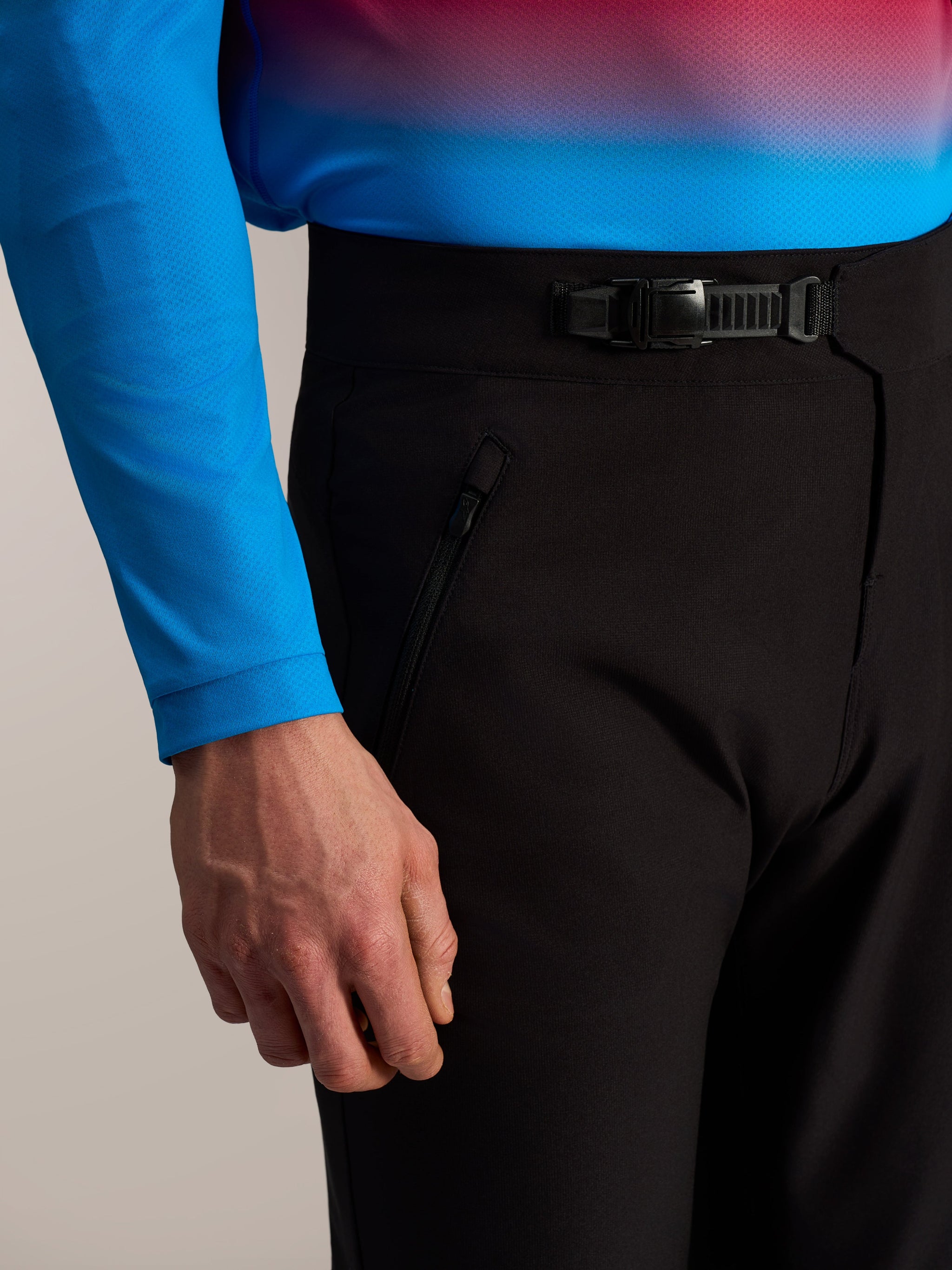 Black A-Dura Ride MTB Pants featuring a front ratchet closure and zippered side pocket for durable trail riding.