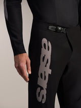 Black Alpinestars A-Supra Elite MTB Pants featuring a ratchet waist closure and bold gray Astars logo on the thigh.
