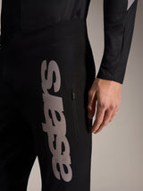 Black A-Supra Elite Pants with a large grey vertical astars wordmark and a zippered side pocket for MTB racing.