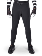Alpinestars A-Aria Elite Pants, Mountain Bike Pants, Black, front view showing laser perforations and magnetic buckle closure, worn with a black and white striped jersey and black gloves, performance cycling gear for trail riding