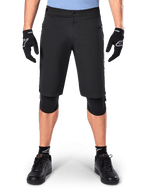 Alpinestars A-Dura Elite Shorts, Black Mountain Bike Shorts, worn by a rider with black gloves and knee pads, featuring front snap closure and zippered pockets, durable Cordura material for off-road cycling
