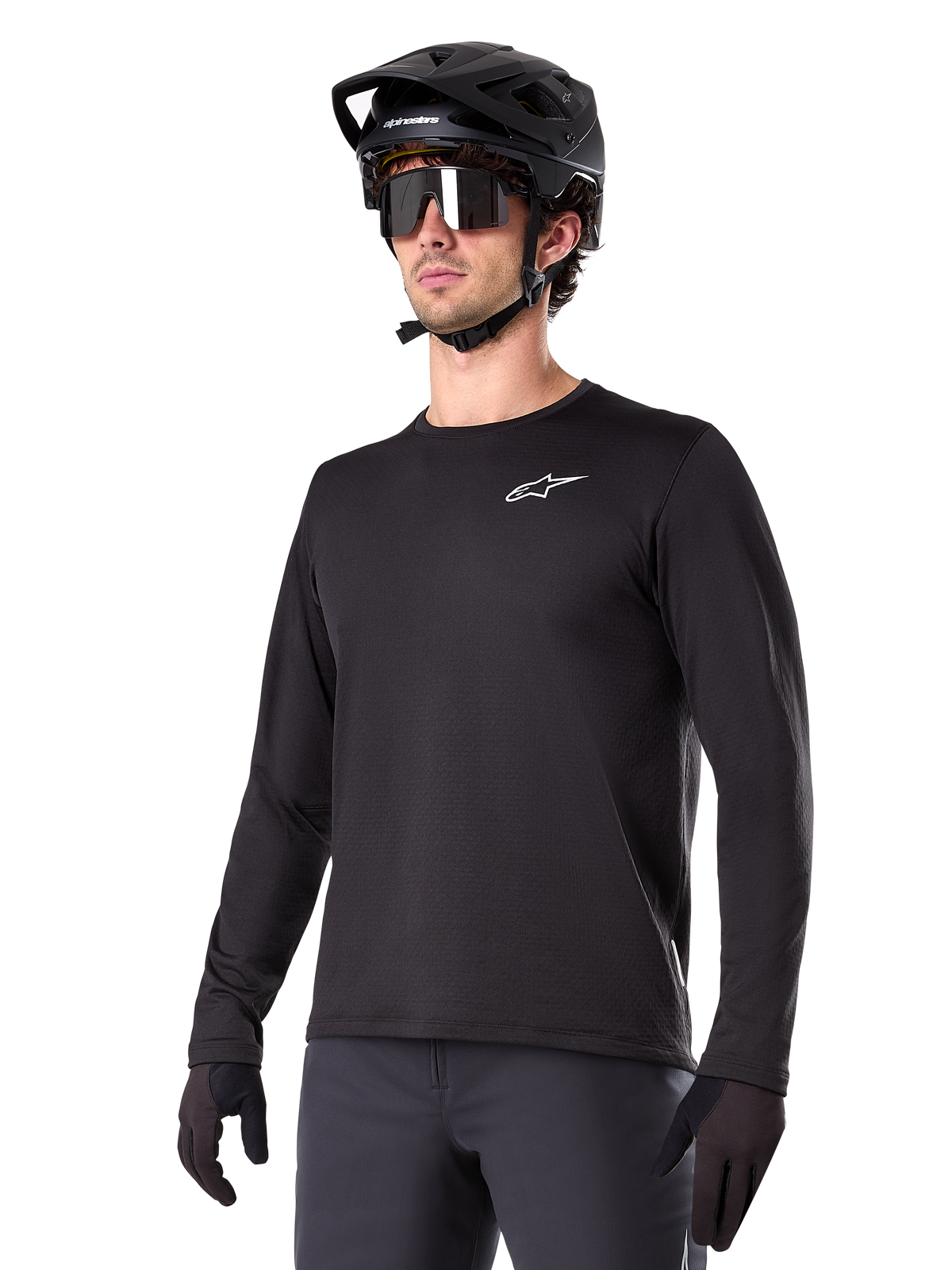 Alpinestars A-Dura Thermal Jersey, Black long-sleeve mountain bike jersey, white chest logo, worn with black helmet and gloves, sleek sporty design for trail riding