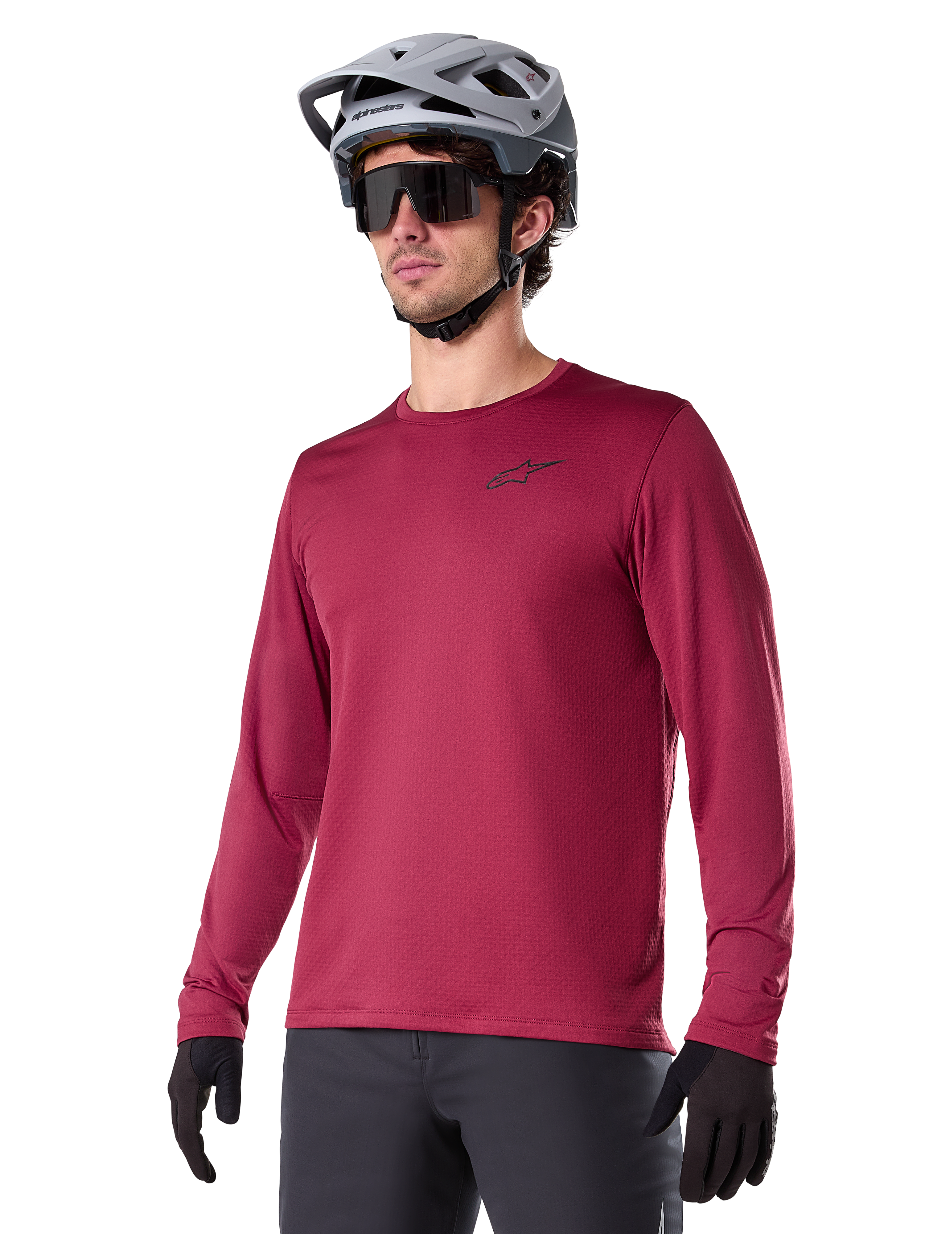 Alpinestars A-Dura Thermal Jersey, Long-Sleeve Mountain Biking Jersey, Burgundy Red, featuring insulated fleece lining and small black chest logo, worn with a gray helmet, black sunglasses, and black gloves, designed for cold-weather cycling