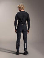 Alpinestars A-Aria Elite Hose, Black Titanium, Rückansicht an männlichem Model, mit silbernem Alpinestars-Branding an den Unterschenkeln, technische MTB-Hose mit Performance-Passform und feuchtigkeitsableitendem Detail am Bund.