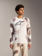 Alpinestars A-Dura Ride Langarmtrikot in Sand Camo, weißes MTB-Top mit abstrakten Mustern und schwarzem Brust-Logo.