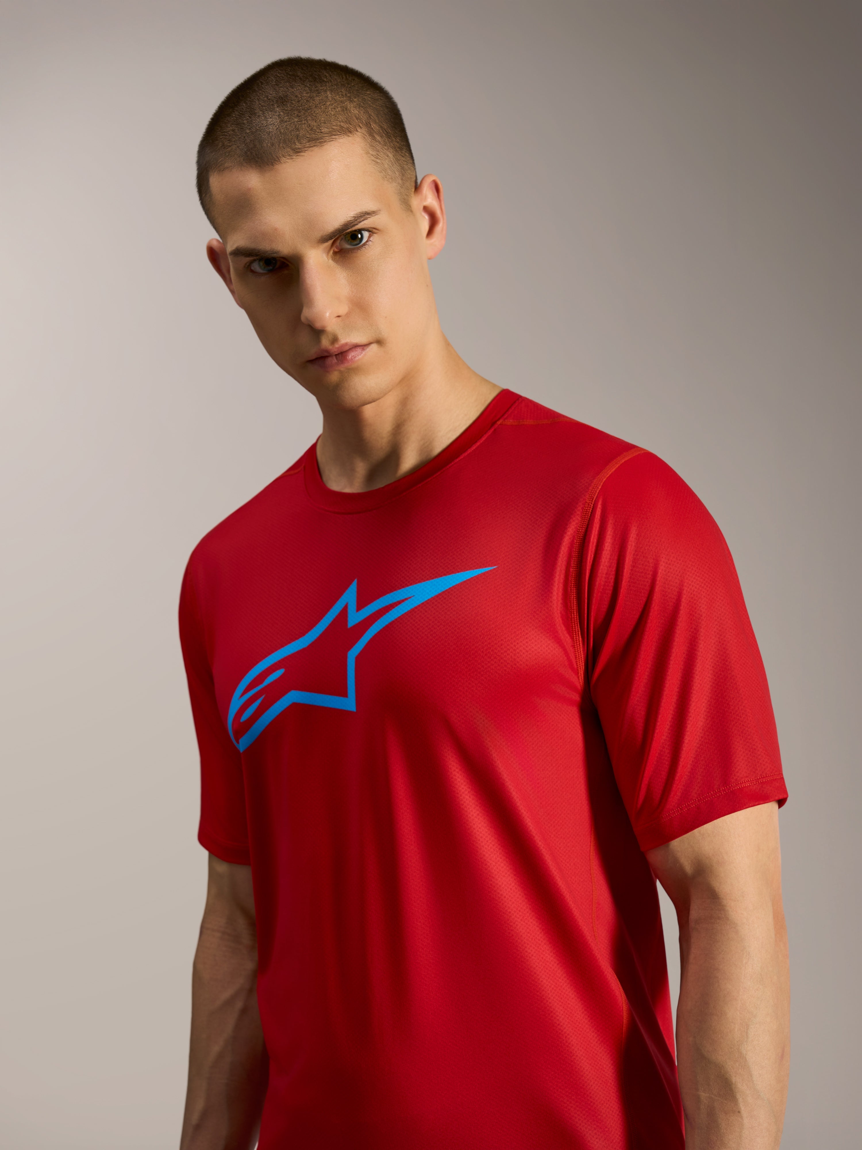 Rotes A-Dura Ride Kurzarmtrikot mit blauem Astars-Logo, leichte Performance-MTB-Bekleidung für Trail-Fahrten.