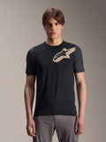 Male model wearing Alpinestars A-Dura Lipan Short Sleeve Jersey, Black MTB mountain bike jersey with beige star logo and dark gray sleeves, paired with gray cycling pants, casual performance apparel