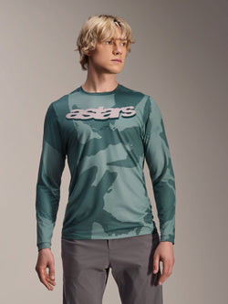 Alpinestars A-Dura Hollow Camo Long Sleeve Jersey, MTB Jersey, Silver Pine Camo green camouflage pattern, large light grey astars logo on chest, worn with grey pants, high-performance mountain biking apparel