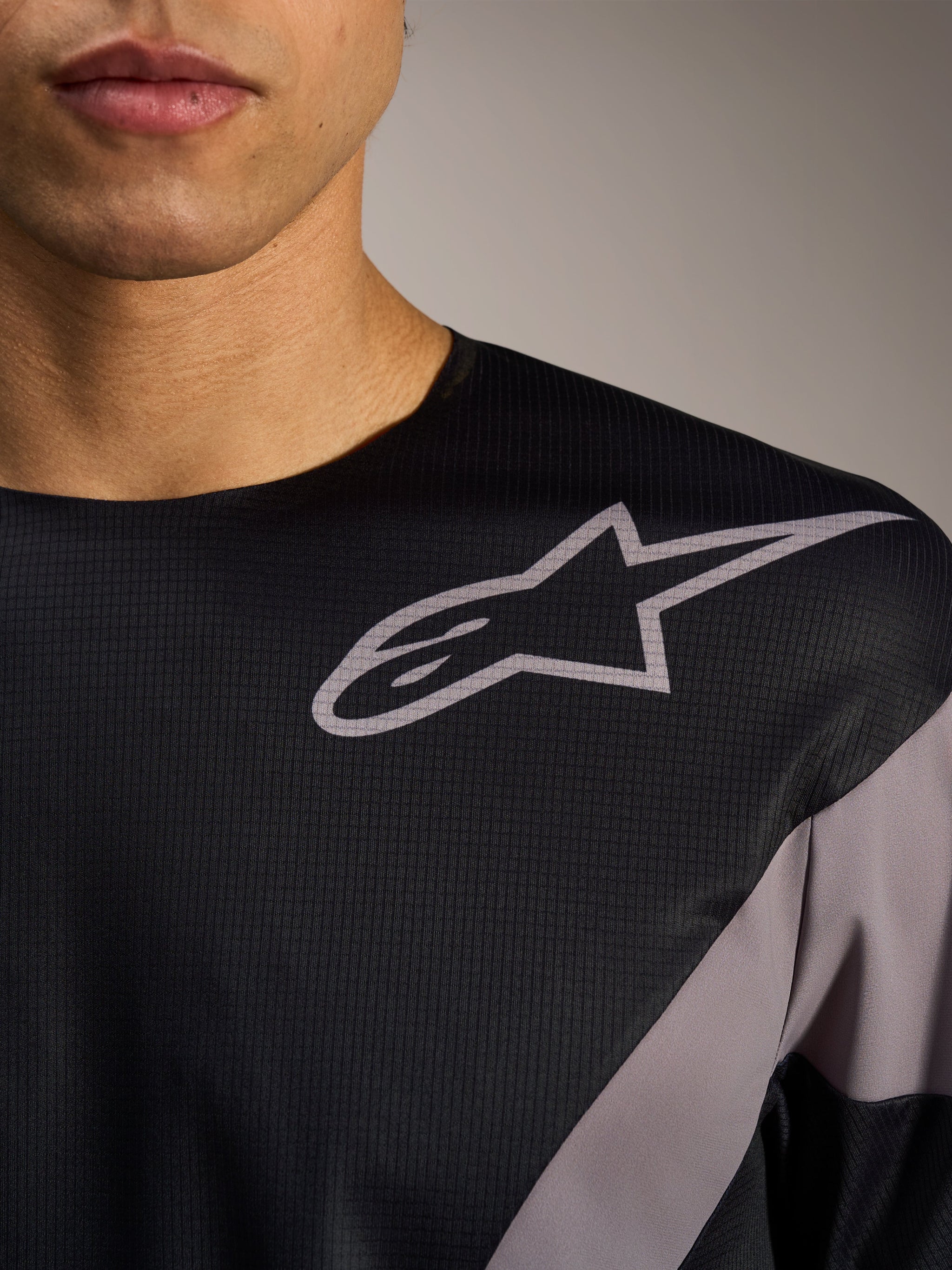 A-Supra Elite Jersey in black, highlighting the grey Astars logo on micro-perforated fabric for MTB performance.