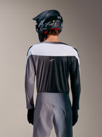 A-Supra Elite Trikot in Faded Gray, Rückansicht mit weißem Paneel, mikroperforiertem Gewebe und zentralem ASTARS-Logo.