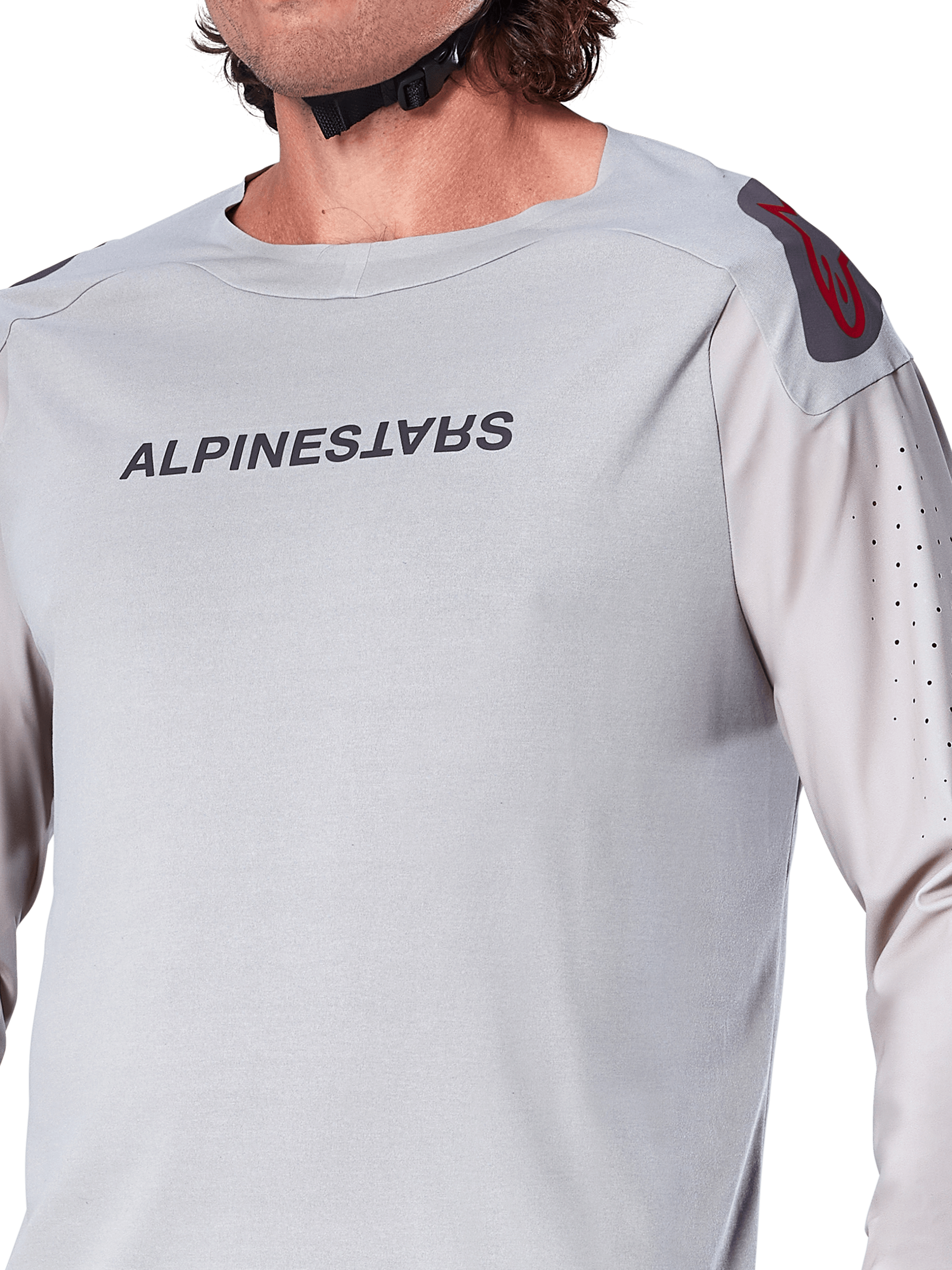 Close-up of the Alpinestars A-Aria Polartec Switch Long Sleeve Jersey in Light Gray, featuring Alpinestars chest branding, red shoulder logo, and laser-perforated sleeves for airflow, premium mountain bike gear.