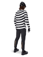 MTB rider wearing the Alpinestars A-Aria Oscar Long Sleeve Jersey, black and white horizontal spiral stripes, paired with black technical pants featuring gold logos on the calves, black helmet and shoes, complete off-road cycling outfit from behind