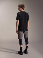 Alpinestars A-Dura Dri Wool Short Sleeve Jersey and A-Dura Elite Shorts, black and dark gray mountain bike apparel, worn with black knee guards and socks, back view of cycling gear for off-road performance