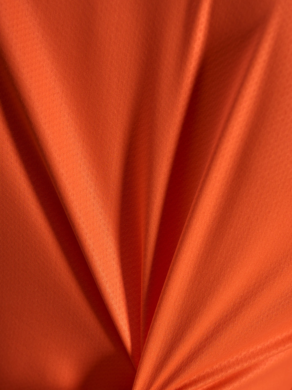 Oranges Jacquard-Stoffdetail des Alpinestars Stella A-Dura Ride Trikots mit leichter und dehnbarer Textur.