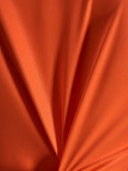 Oranges Jacquard-Stoffdetail des Alpinestars Stella A-Dura Ride Trikots mit leichter und dehnbarer Textur.