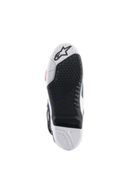 Alpinestars Tech 10 Supervented Boots sole, bottom view featuring a black and white dual-compound design, honeycomb grip texture, replaceable central insert, and embossed Alpinestars logo, optimized for motocross foot-peg performance.