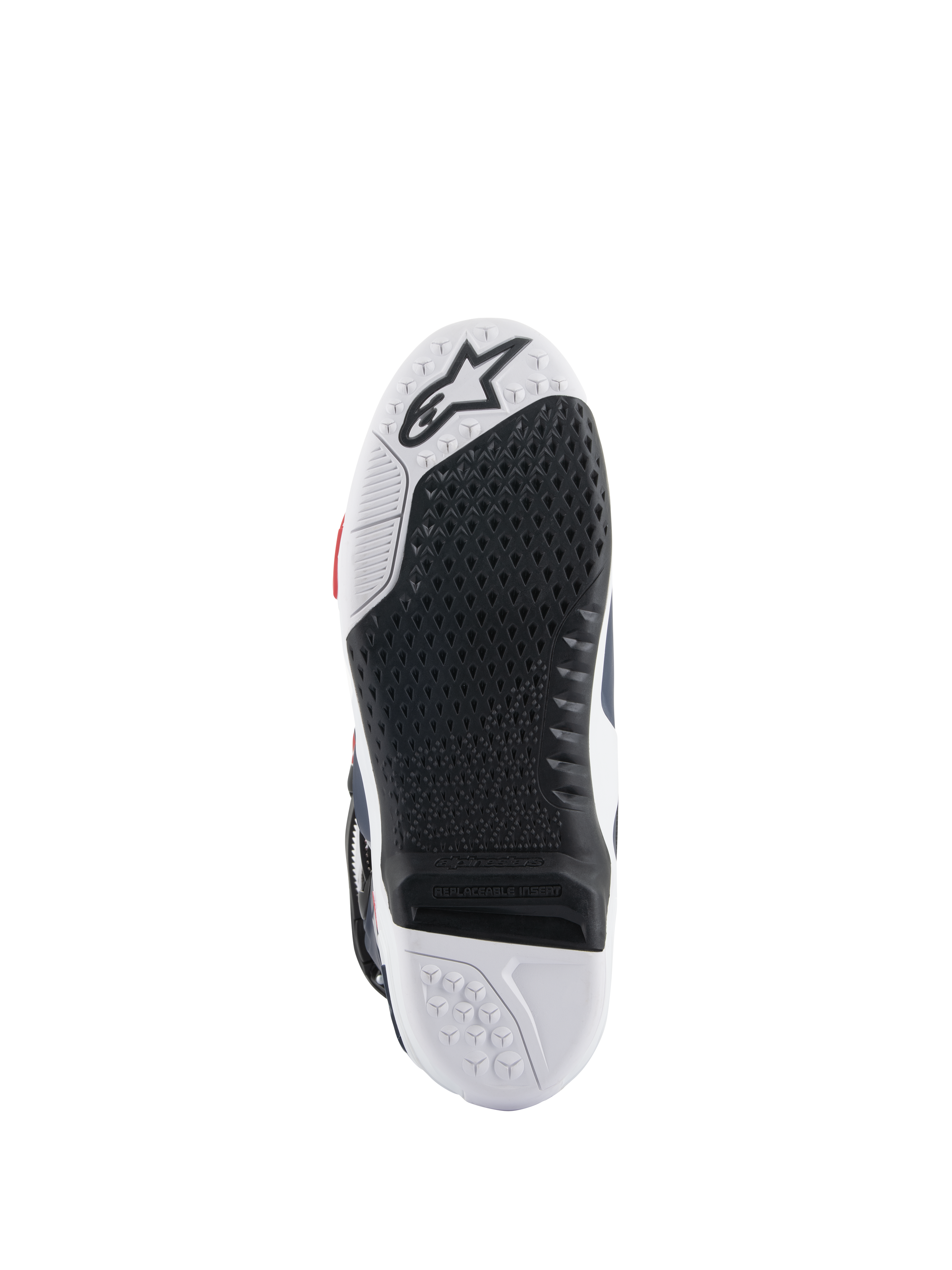 Alpinestars Tech 10 Supervented Boots sole, bottom view featuring a black and white dual-compound design, honeycomb grip texture, replaceable central insert, and embossed Alpinestars logo, optimized for motocross foot-peg performance.