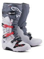 Alpinestars Tech 7 Enduro Boots, off-road motorcycle footwear, Light Gray and Dark Gray with Bright Red accents, featuring a multi-buckle closure system and a rugged compound sole designed for enduro and trail riding.
