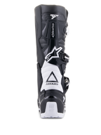 Alpinestars Tech 7 Enduro Drystar Stiefel, Schwarz und Weiß, Rückansicht mit TPU-Schutzstruktur, weißen Akkordeon-Flexzonen und Schnallenverschlusssystem, Alpinestars-Branding an Ferse und Schaft