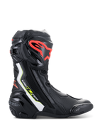 Alpinestars Supertech R Boots, high-performance motorcycle racing boots in black with white, red fluo, and yellow fluo accents, featuring a protective TPU shin plate with a red logo, replaceable toe slider, and sleek aerodynamic profile.