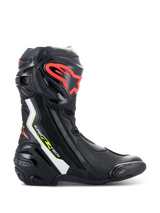 Alpinestars Supertech R Boots, high-performance motorcycle racing boots in black with white, red fluo, and yellow fluo accents, featuring a protective TPU shin plate with a red logo, replaceable toe slider, and sleek aerodynamic profile.